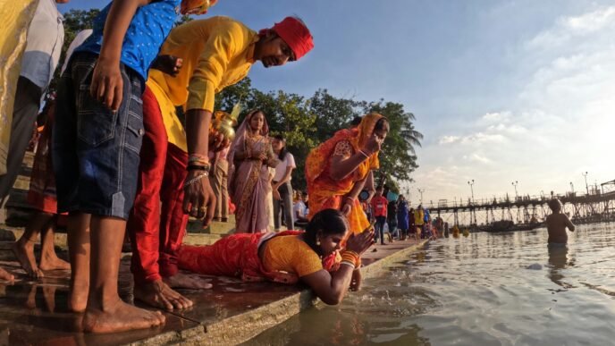 a group of people standing around a body of water